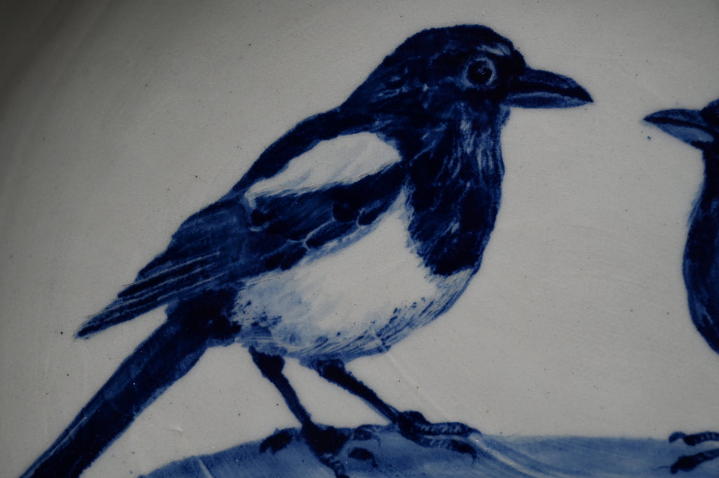 Ronde schaal met ekster en merel