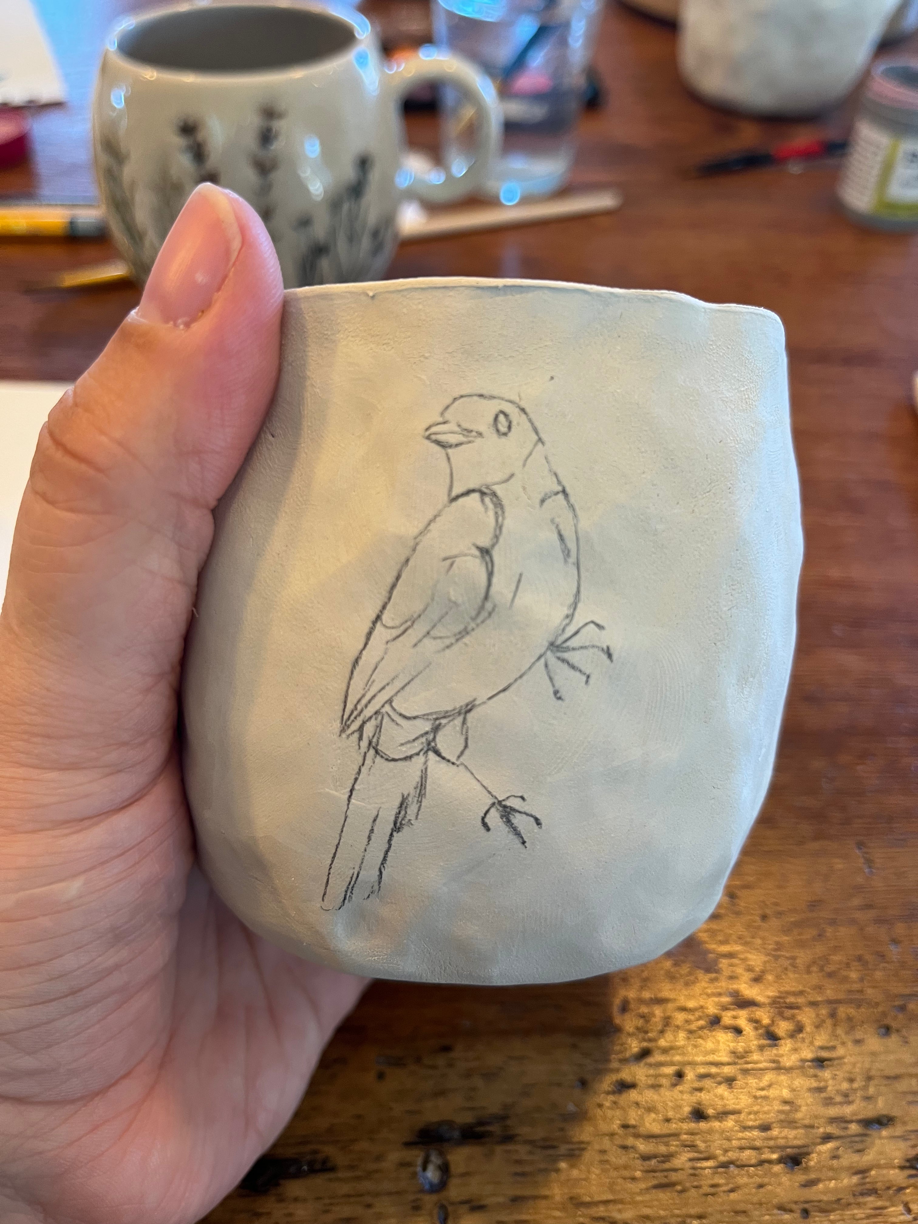 Handgeknepen mok met merel op tak